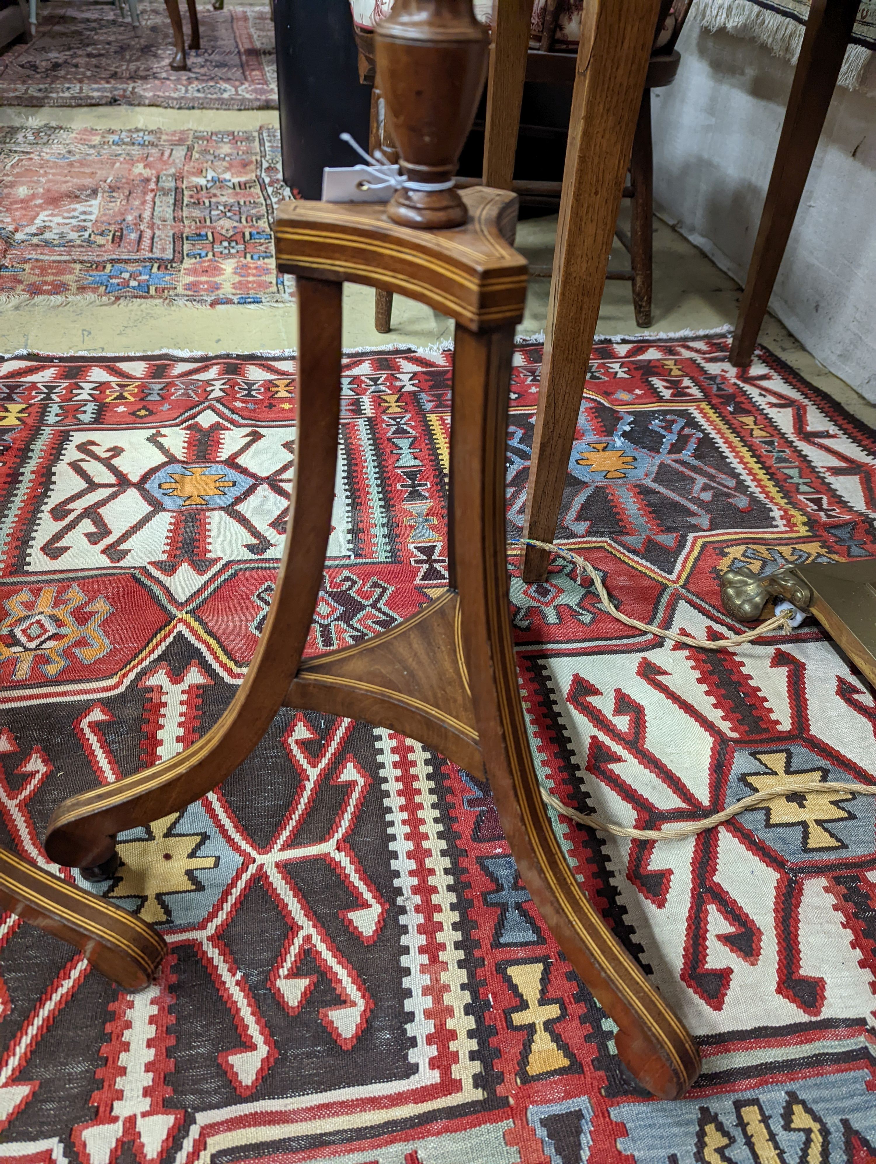 A pair of 19th century mahogany pole screens, with oval silkwork banners, height 148cm